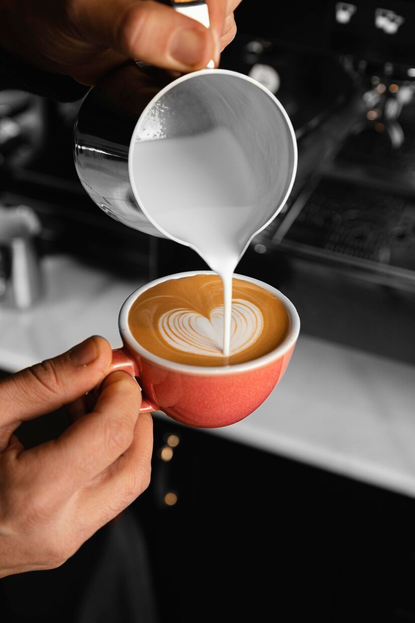 close-up-hand-pouring-milk-coffee_23-2148865576