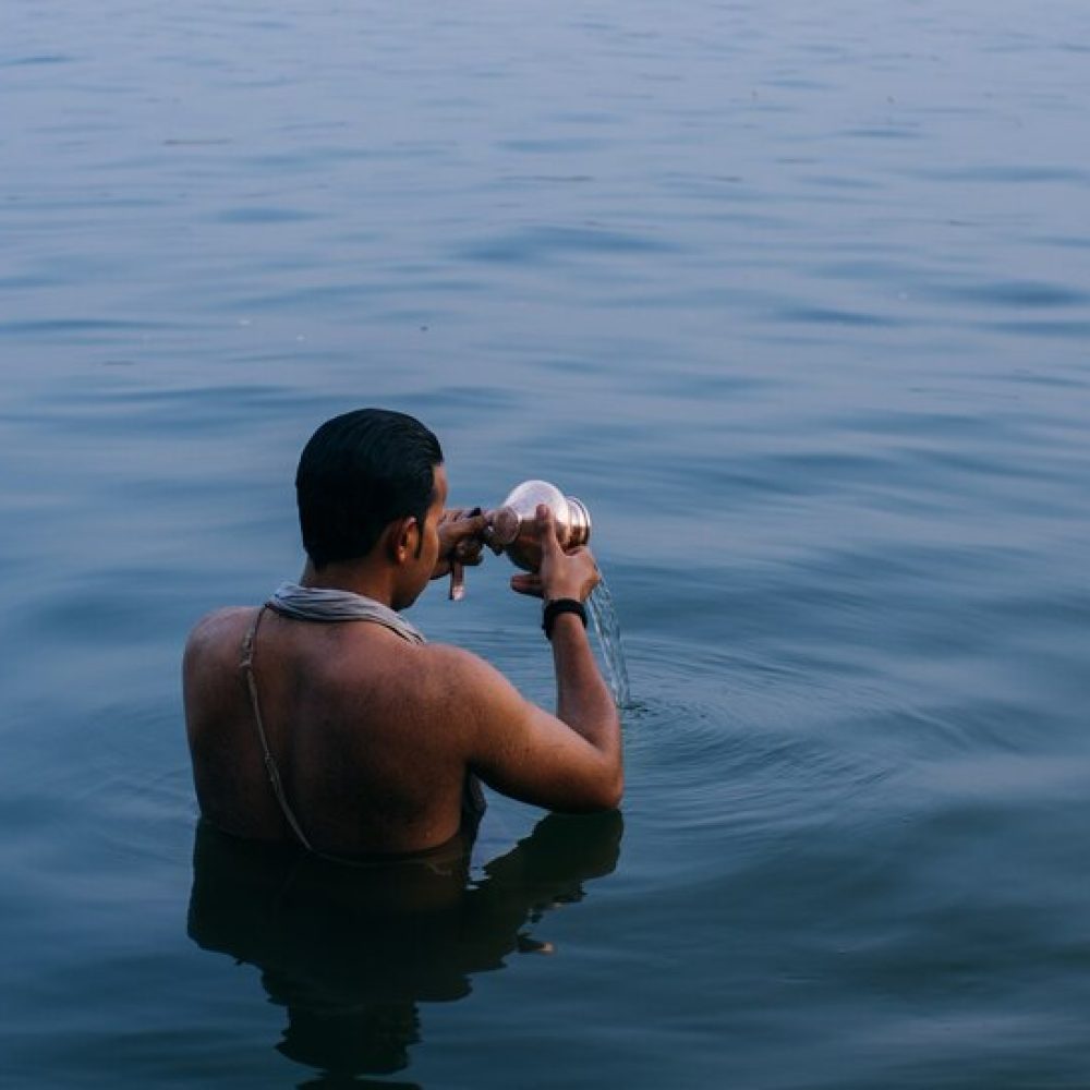 person-standing-water-while-emptying-copper-bowl-india_181624-12542-r9wwnt150nuldl32o74ot6olfn3pmjm6v0ovjj6uxc