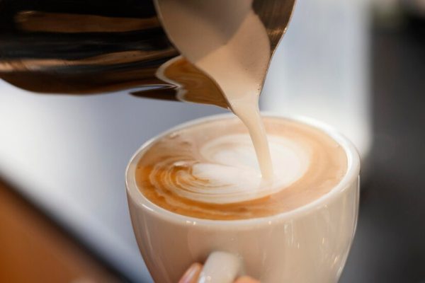 close-up-hand-holding-coffee-cup_23-2148892838