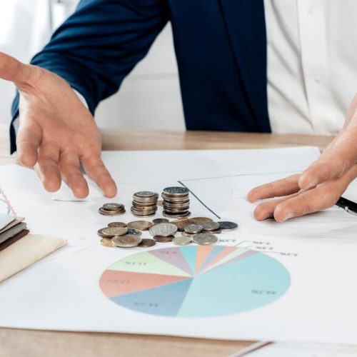 close-up-man-with-coins-statistics_23-2148773975