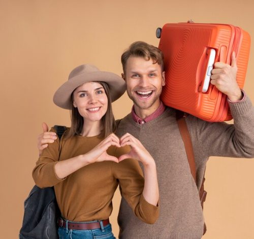 smiley-couple-ready-traveling-with-luggage_23-2149205288